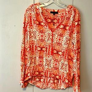 Long sleeve tunic top. Orange and red print. Never been worn.